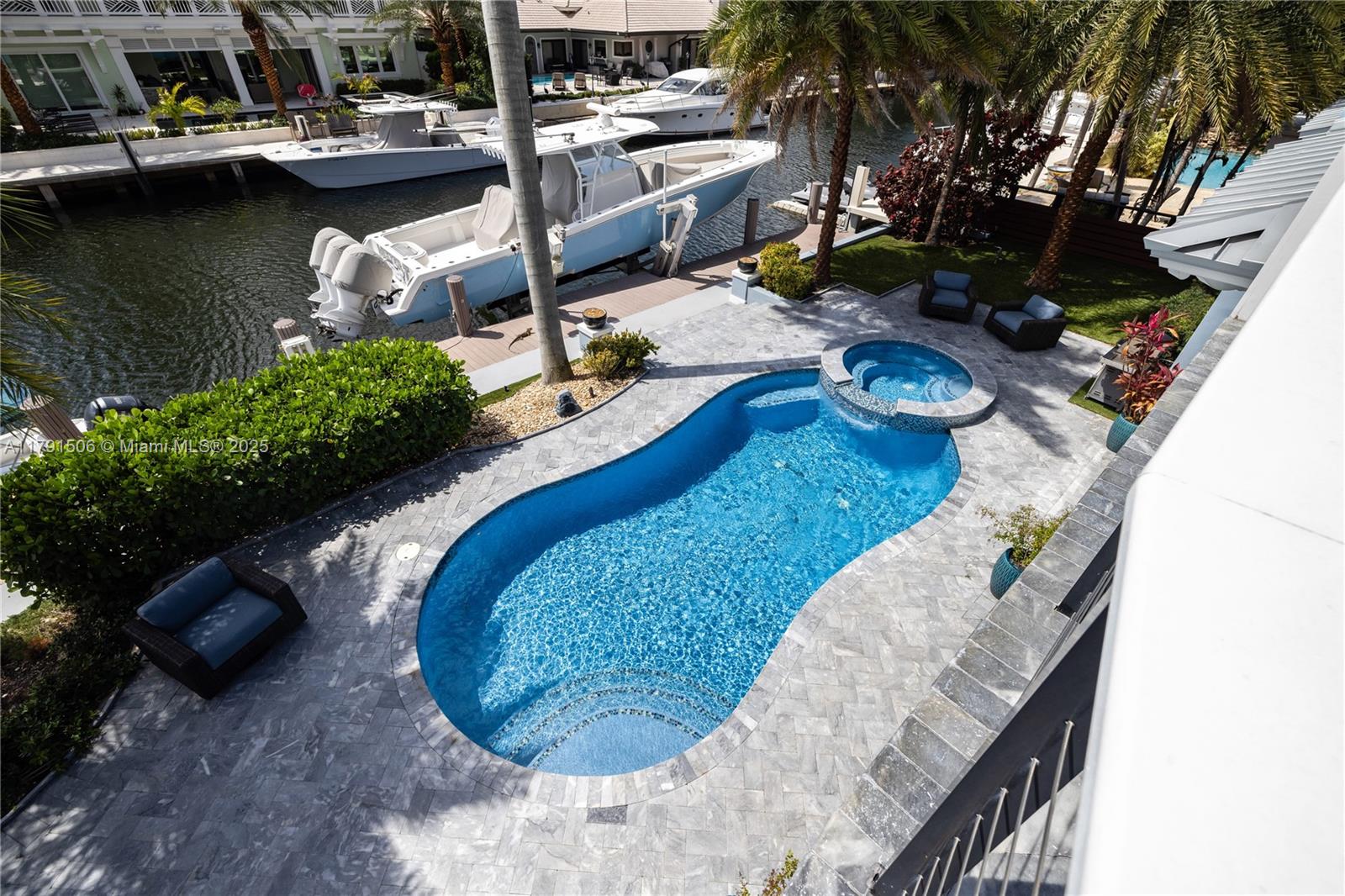 2340 Northeast 48th Street Lighthouse Point, FL 33064 - Photo 46 of 48 a view of a swimming pool with lounge chair
