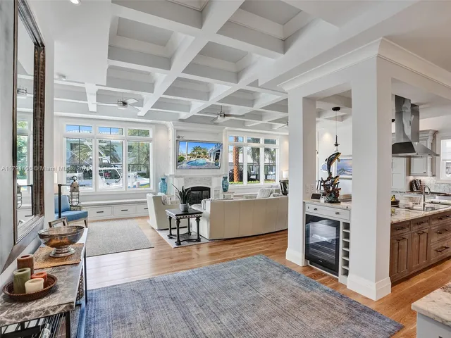a living room with fireplace furniture and a large window