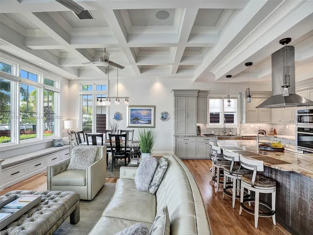 a living room with lots of furniture and kitchen view