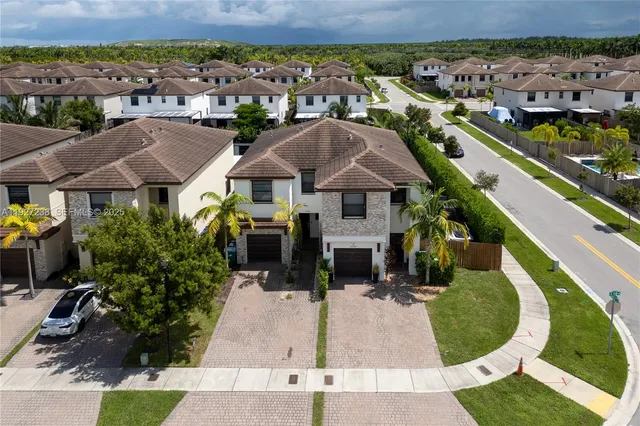 an aerial view of a house with garden space and street view