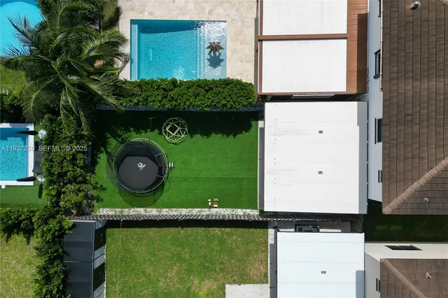 a view of small space with a car parked in front of it