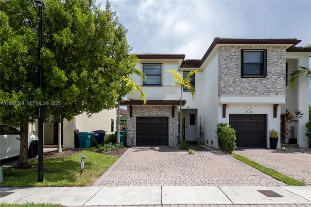 a front view of a house with a yard and garage