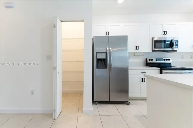 a kitchen with stainless steel appliances a refrigerator and a sink