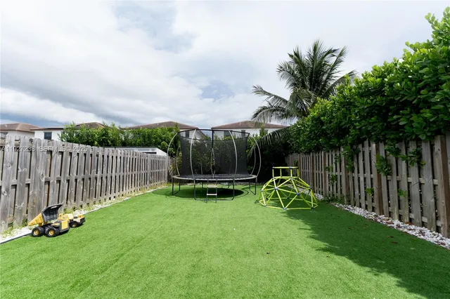 a view of backyard with a garden and deck