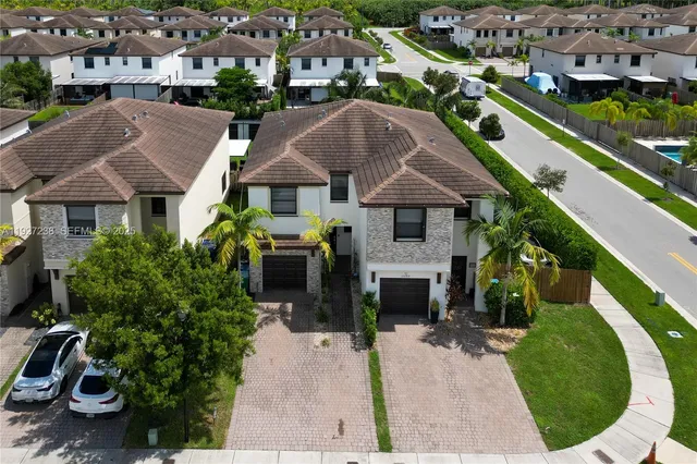 an aerial view of a house with garden space and street view