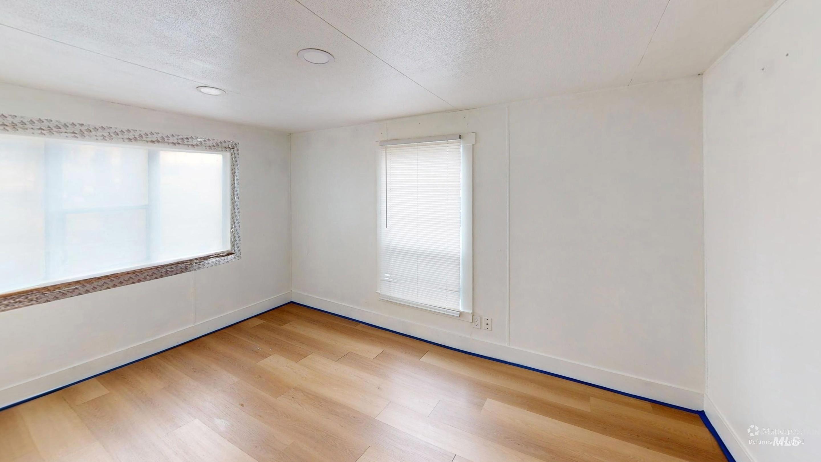 19151 Symms Road Caldwell, ID 83607 - Photo 13 of 14 Unfurnished room featuring light wood-style flooring and a textured ceiling
