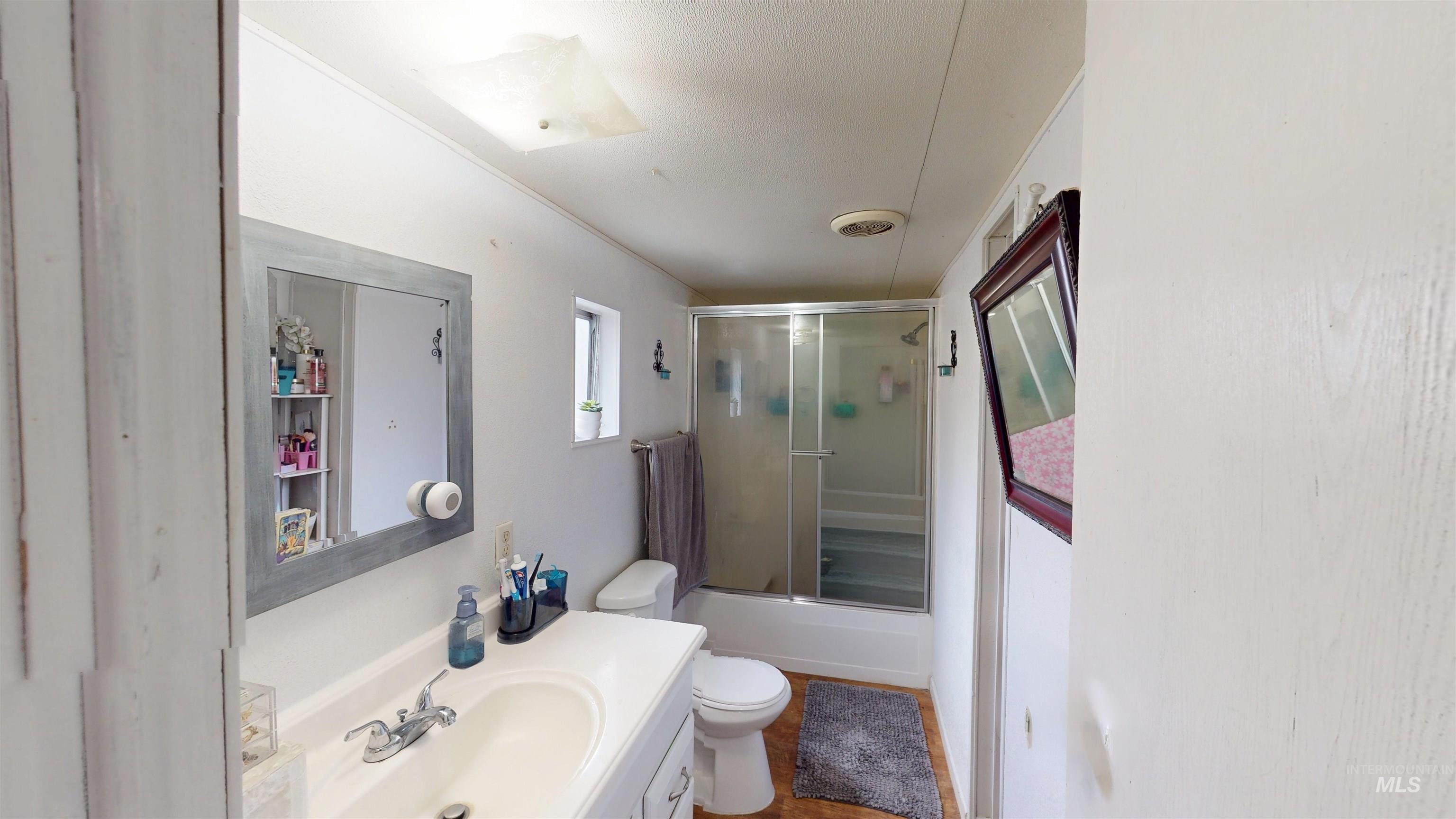 19151 Symms Road Caldwell, ID 83607 - Photo 7 of 14 Bathroom with vanity and enclosed tub / shower combo