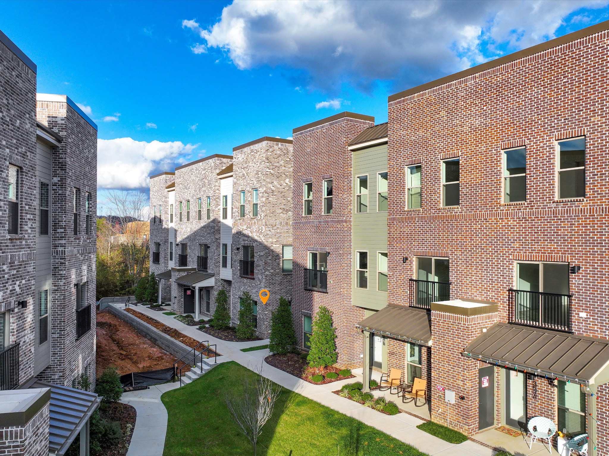 a front view of a residential apartment building with a yard