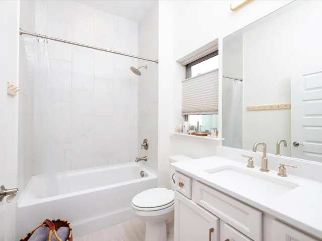 a en suite bathroom with a sink a mirror and a shower