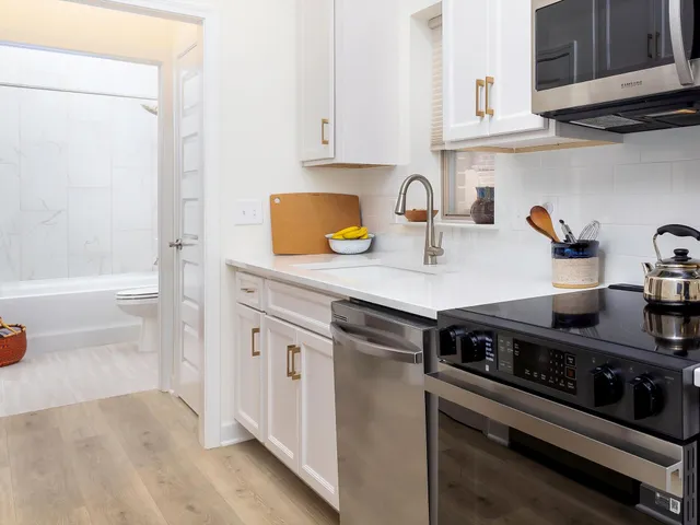 a kitchen with a sink and a wooden cabinets
