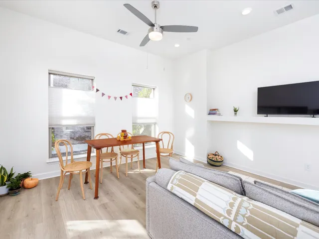 a view of a livingroom with furniture window and wooden floor