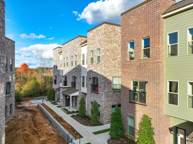 a front view of a residential apartment building with a yard