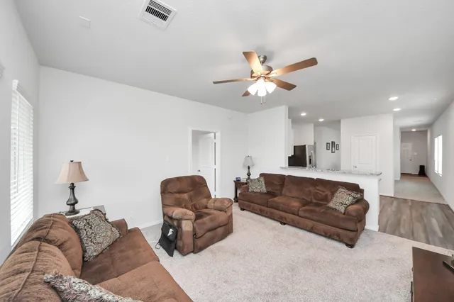 a living room with furniture a couch and a chandelier