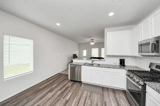 a kitchen with a sink stove and microwave