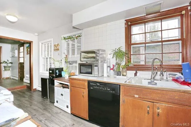 a kitchen with stainless steel appliances granite countertop a sink a stove and a refrigerator