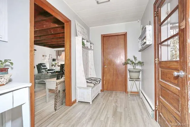 a view of a hallway view with wooden floor and furniture