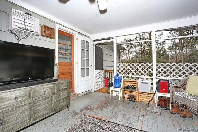 a living room with furniture and flat screen tv