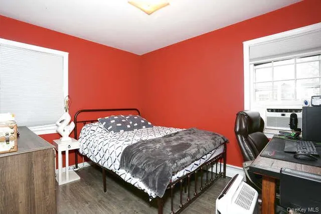 a bedroom with a bed chair and a window