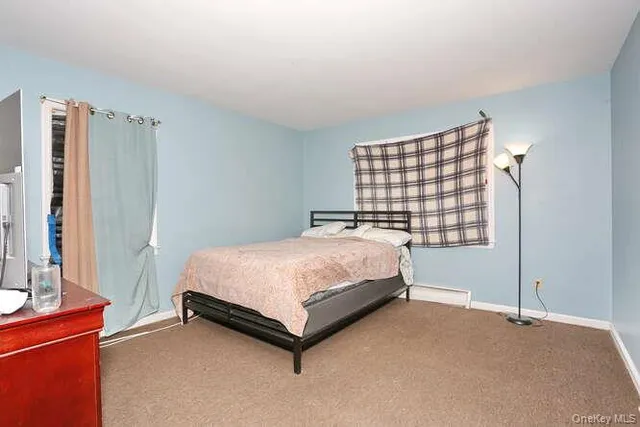 a bed sitting in a bedroom next to a window