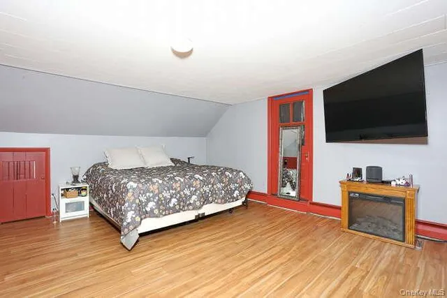 a bedroom with a bed and a flat screen tv