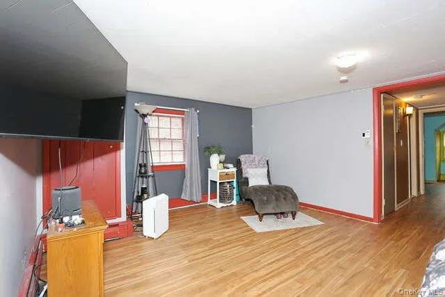 a living room with furniture lamp and wooden floor