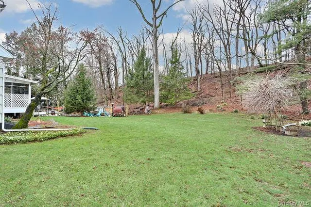 a view of a house with backyard and sitting area
