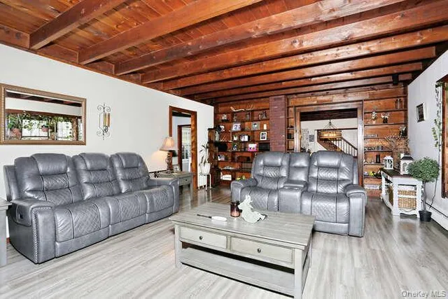 a living room with furniture and wooden floor