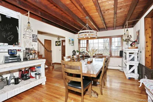 a view of a dining room with furniture window and wooden floor