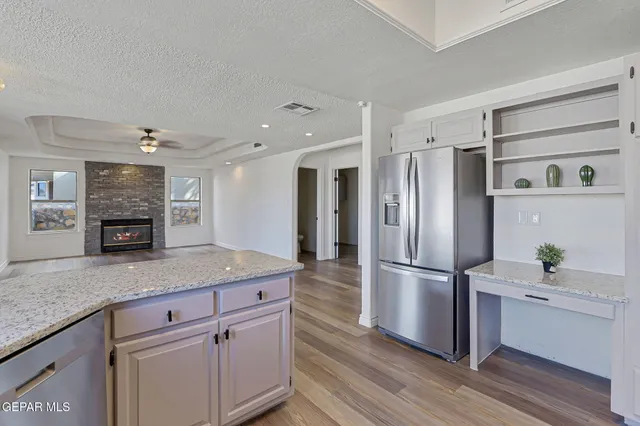 a kitchen with a sink a stove and cabinets