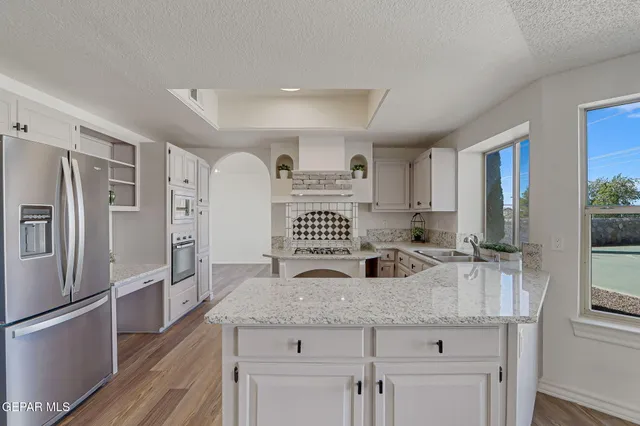 an empty room with wooden floor and fireplace