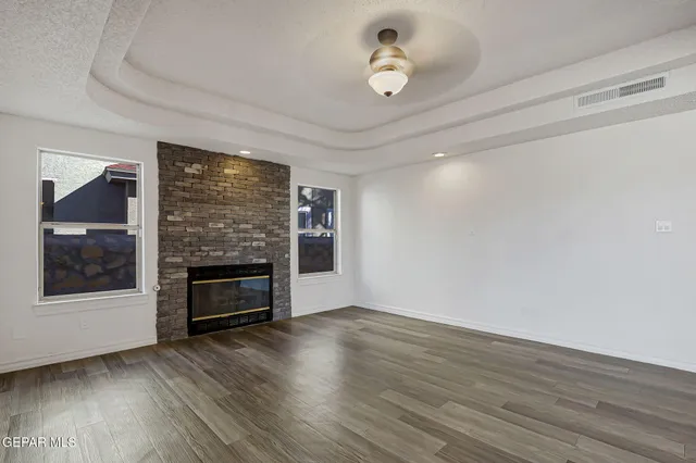wooden floor in an empty room with a fireplace