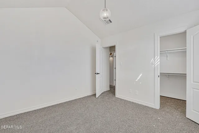 a view of a room with a ceiling fan