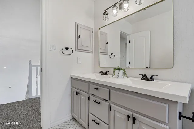 a bathroom with a double vanity sink and a mirror