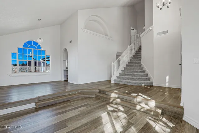 a view of a room with wooden floor and white walls