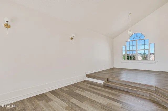a view of a hallway with wooden floor and entryway
