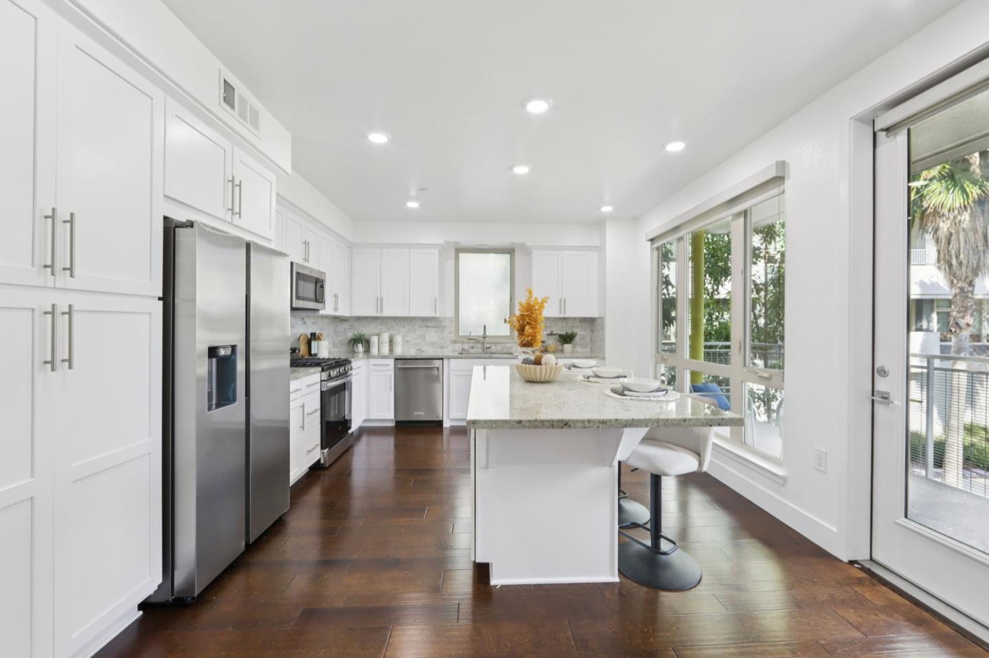 390 Riesling Avenue, Unit 21 Milpitas, CA 95035 - Photo 11 of 48 a kitchen with stainless steel appliances granite countertop a refrigerator and a stove top oven