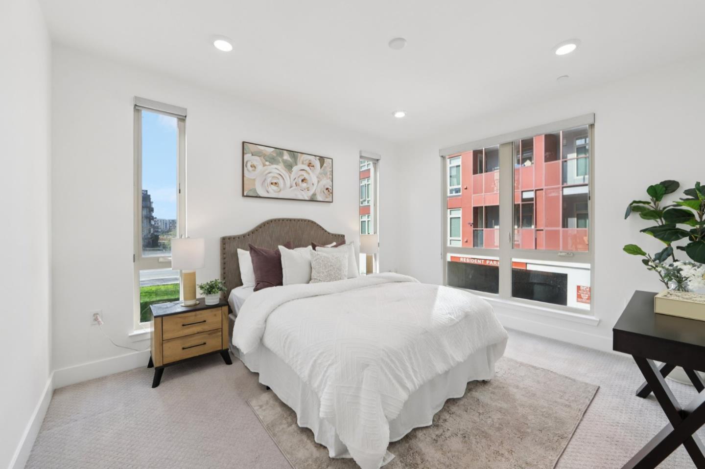 390 Riesling Avenue, Unit 21 Milpitas, CA 95035 - Photo 19 of 48 a spacious bedroom with a bed a couch and potted plant in it