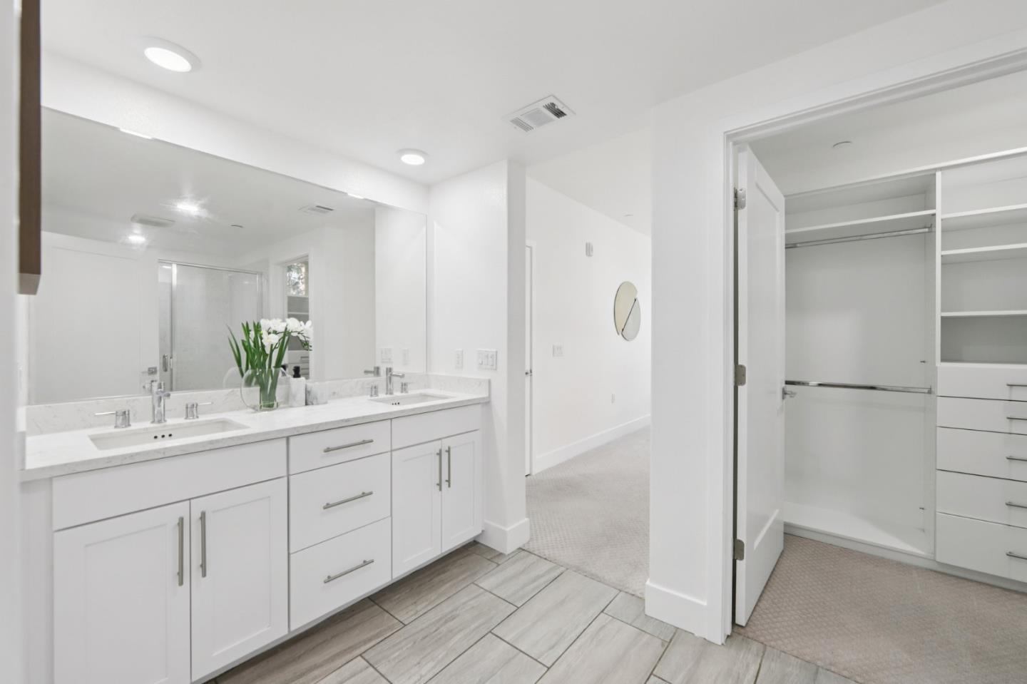 390 Riesling Avenue, Unit 21 Milpitas, CA 95035 - Photo 21 of 48 a spacious bathroom with a double vanity sink a mirror and a shower