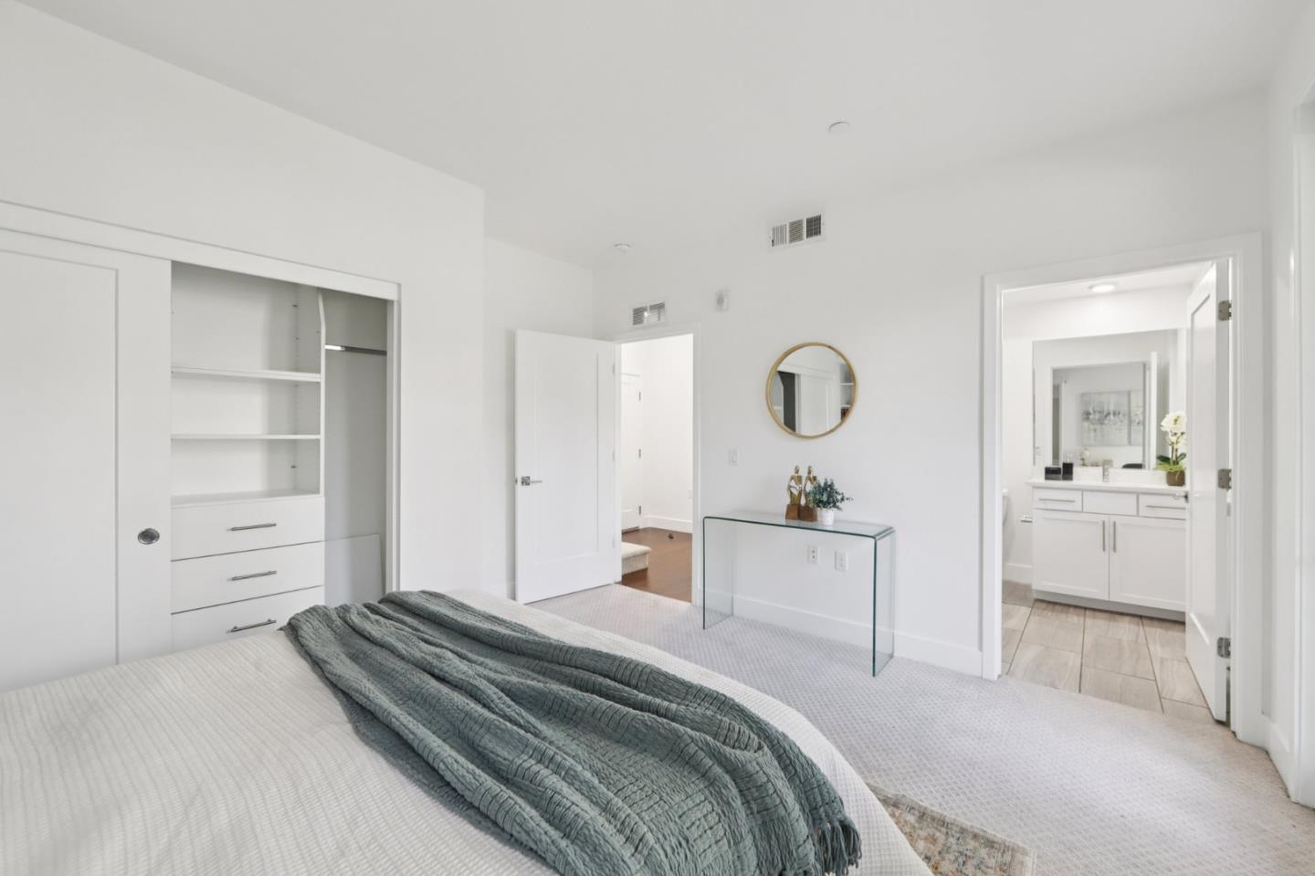 390 Riesling Avenue, Unit 21 Milpitas, CA 95035 - Photo 25 of 48 a bedroom with a bed and a cabinets