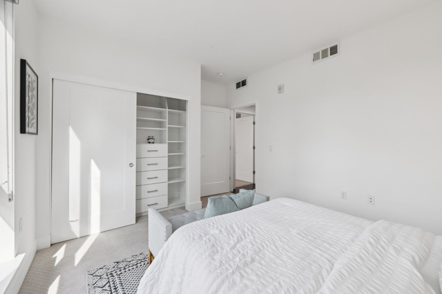 390 Riesling Avenue, Unit 21 Milpitas, CA 95035 - Photo 28 of 48 a bedroom with a bed and a closet