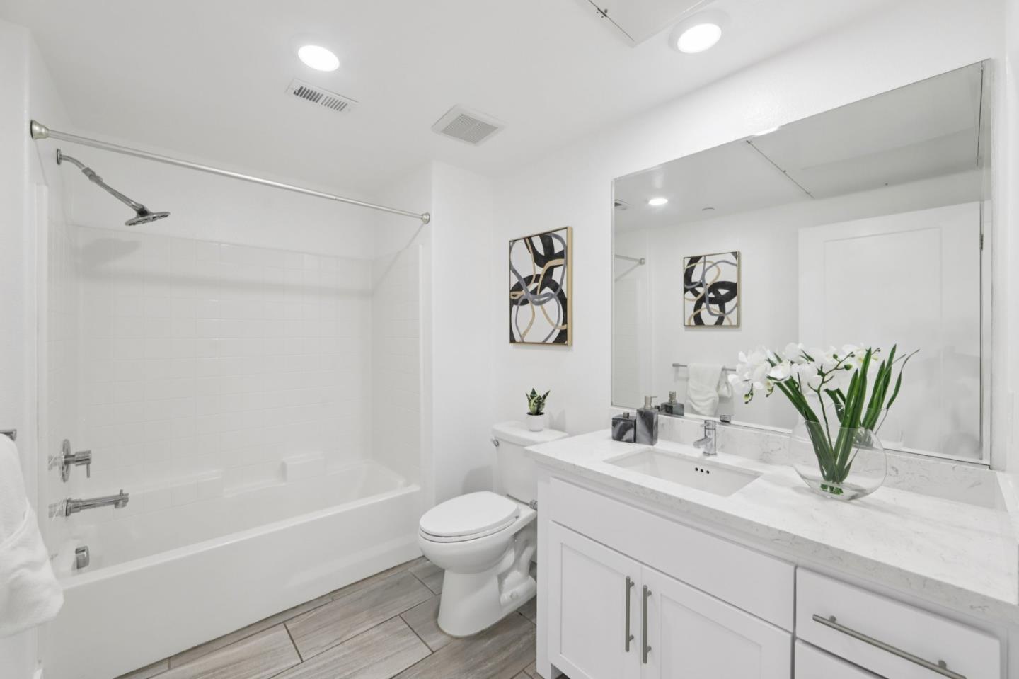 390 Riesling Avenue, Unit 21 Milpitas, CA 95035 - Photo 30 of 48 a bathroom with a granite countertop sink a toilet and bathtub