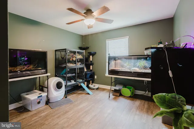 a room with wooden floor and gym equipment