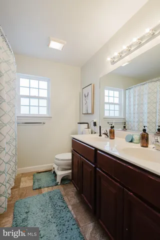 a bathroom with a toilet sink and mirror