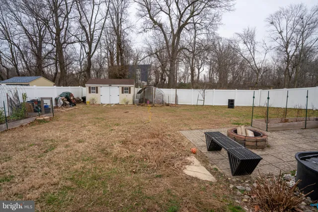 a view of a backyard with table and chairs