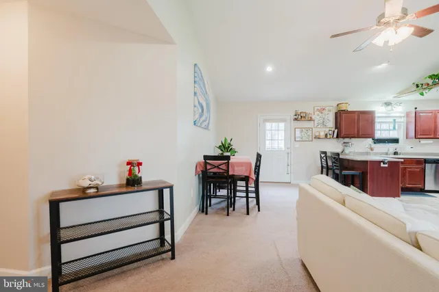 a living room with furniture and a kitchen view