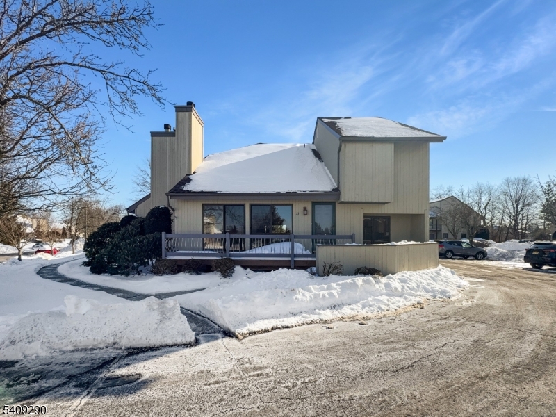 a view of a house with a yard covered in snow