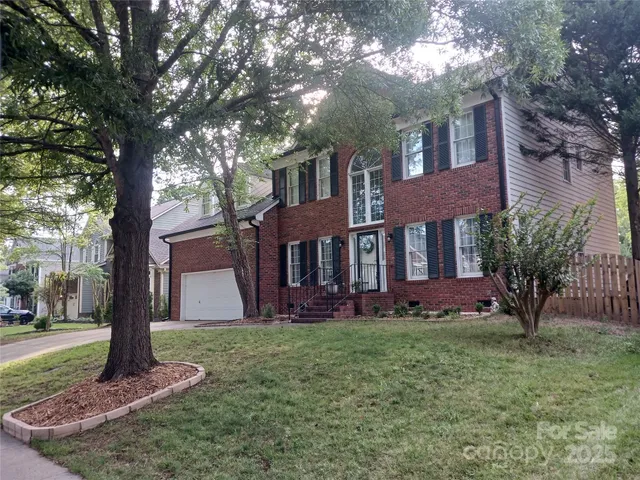 a front view of house with yard and green space