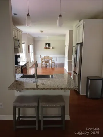 a kitchen with granite countertop a counter space cabinets and stainless steel appliances