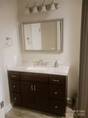 a bathroom with a sink vanity and mirror
