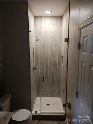 a bathroom with a shower a toilet and a sink
